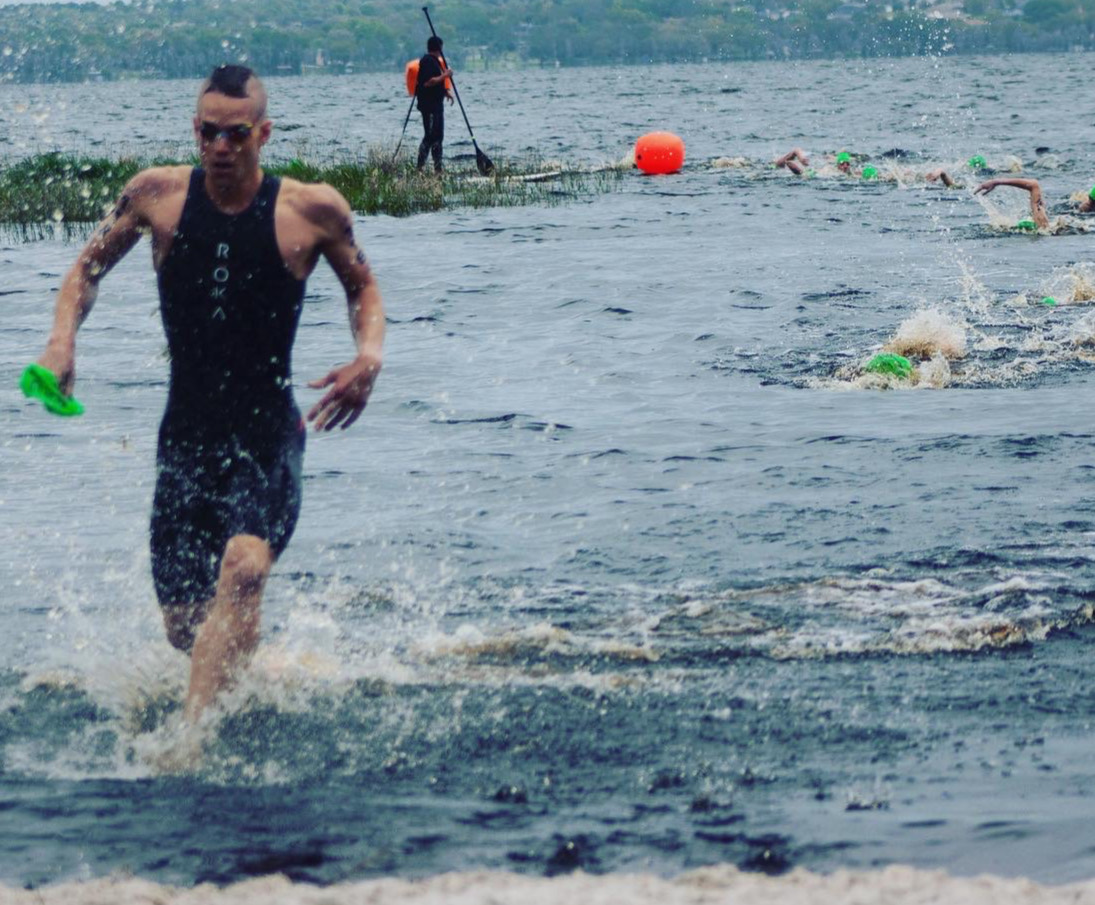 Triathlete running out of the open water